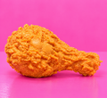 Jumbo Chicken Drumstick Squishy on plain pink table and background