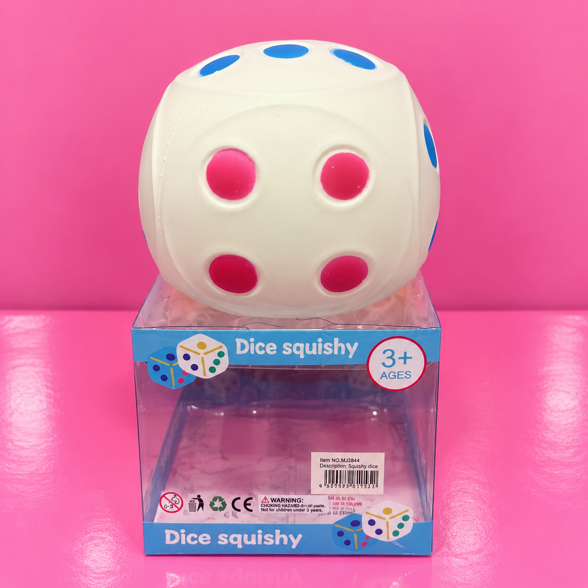 Jumbo Dice Squishy on pink table and backdrop
