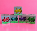 Actual Minecraft squishy cube cases on pink background and table