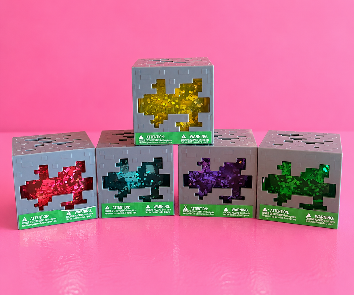Actual Minecraft squishy cube cases on pink background and table