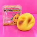 Jelly filled mouldable potato squishy and box on pink background