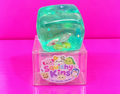 Sea Life Filled Cube Squishy with box on pink table and background