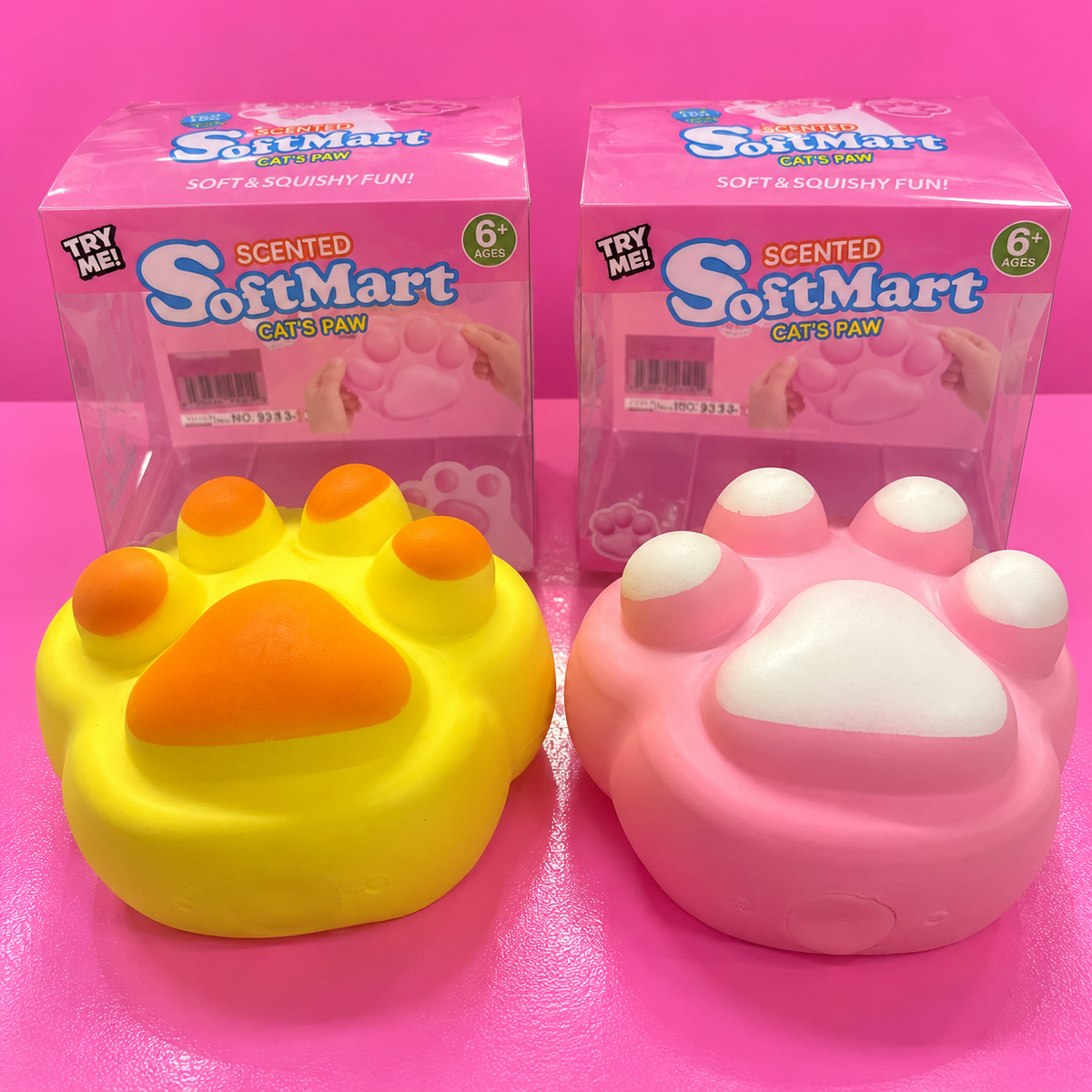 Pink and yellow SoftMart jumbo paw squishies on pink background